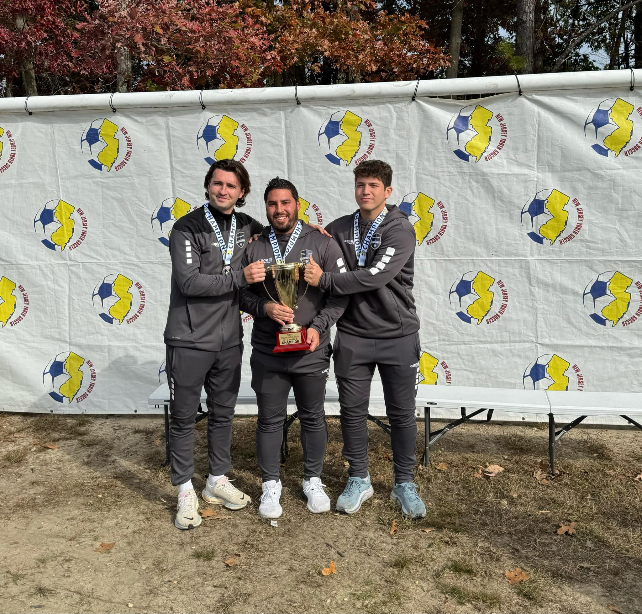 Deptford Soccer Association coaches celebrating a State Cup championship